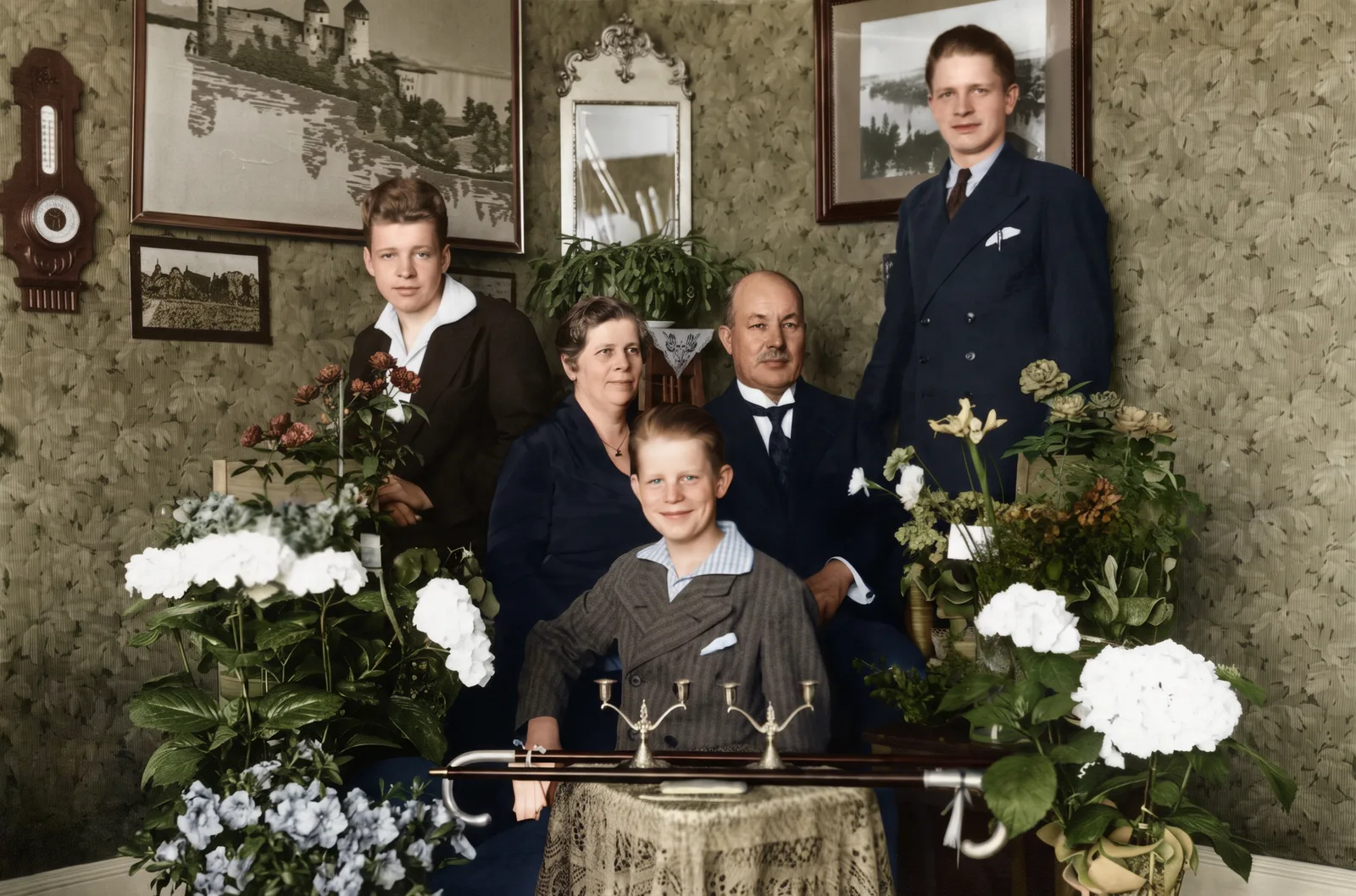 Restored: A family of five posed in a parlor among hydrangeas, early 1900s